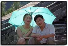 un couple de Chinois sur la muraille, à l'abri du soleil par un parapluie